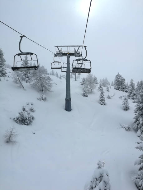 istock Chair lift snow mountain gloomy day 944860086