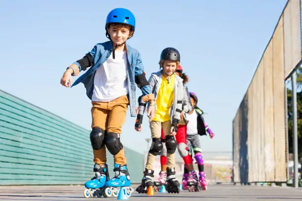 Photo of Cute inline skater avoiding cones at slalom course