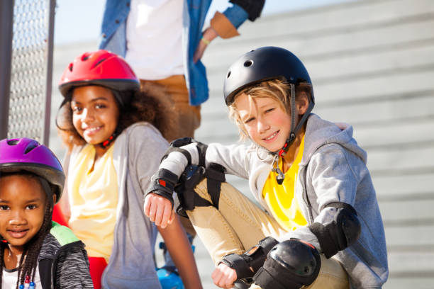 istock Preteen boy in roller helmet sitting at stadium 944864254