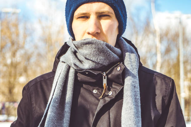 istock young man in warm clothes and scarf on a winter day 944864732