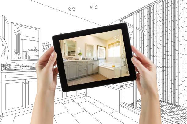 istock Hands Holding Computer Tablet with Master Bathroom Photo on Screen and Drawing Behind 944867934