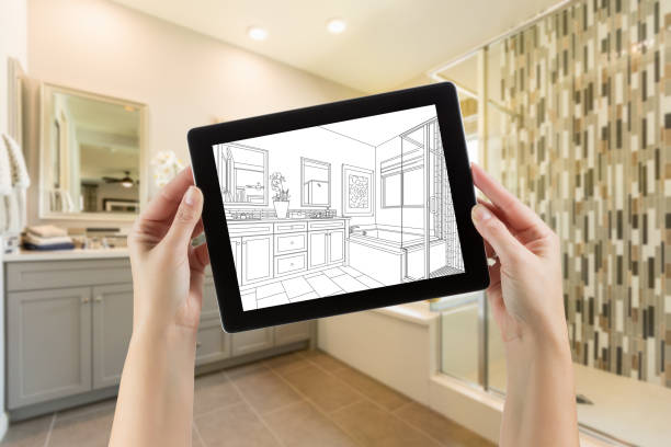 istock Hands Holding Computer Tablet with Master Bathroom Drawing on Screen and Photo Behind 944867936