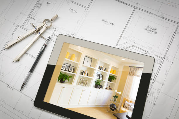 istock Computer Tablet with Finished Built-in Shelves and Cabinets Over House Plans, Pencil and Compass. 944868078