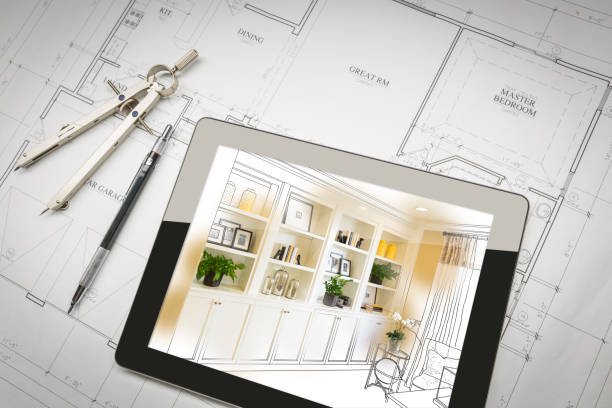 istock Computer Tablet with Finished Built-in Shelves and Cabinets Over House Plans, Pencil and Compass. 944868082