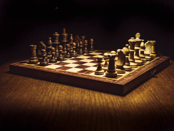 istock isolated checkmate board on the table with black background