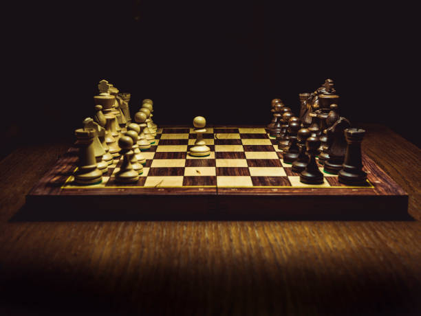istock chess board on the table, first move close-up shot