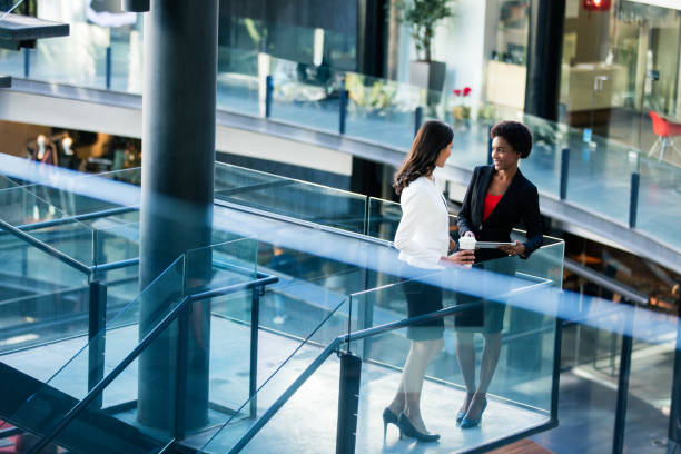 istock Young female office workers standing on balcony and smiling 944869458