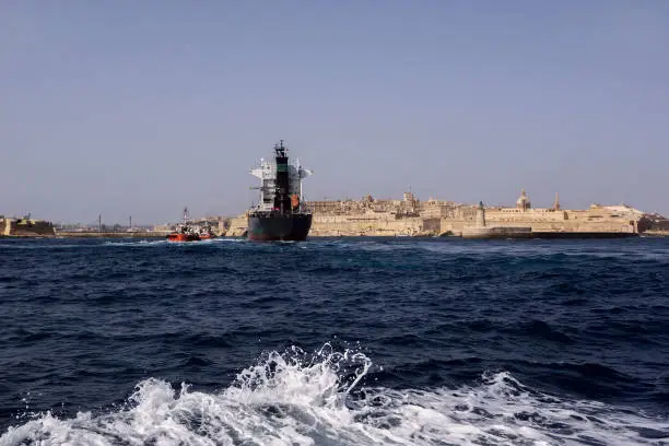 Big cargoship moors to port of island of Malta.