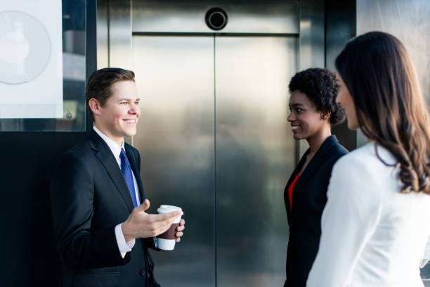 istock Young business people standing and waiting for the elevator 944869474