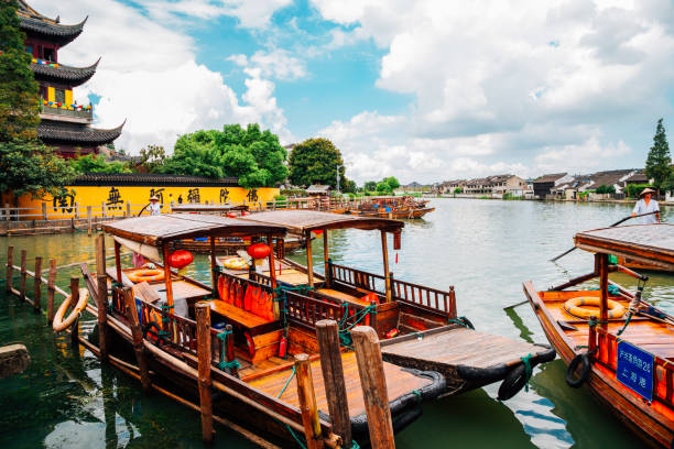 Chinese traditional wooden boats on canal of Shanghai Zhujiajiao water town Shanghai, China - August 8, 2016 : Chinese traditional wooden boats on canal of Shanghai Zhujiajiao water town Zhujiajiao stock pictures, royalty-free photos & images