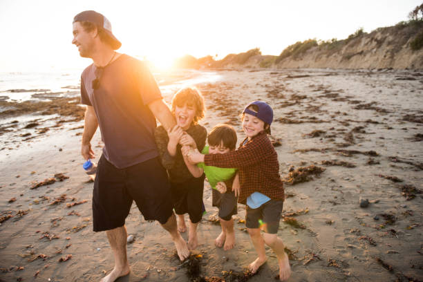 Family enjoying a beautiful sunset in the tide pools of Santa Barbara, father and son spend quality time together.