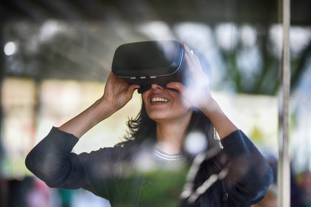 Young woman looking with VR behind the glass