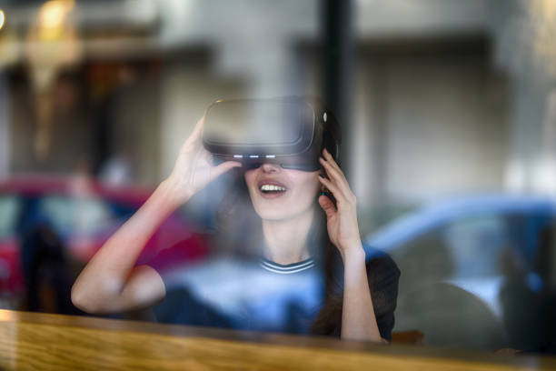 istock Young woman looking with VR behind the glass 944889958