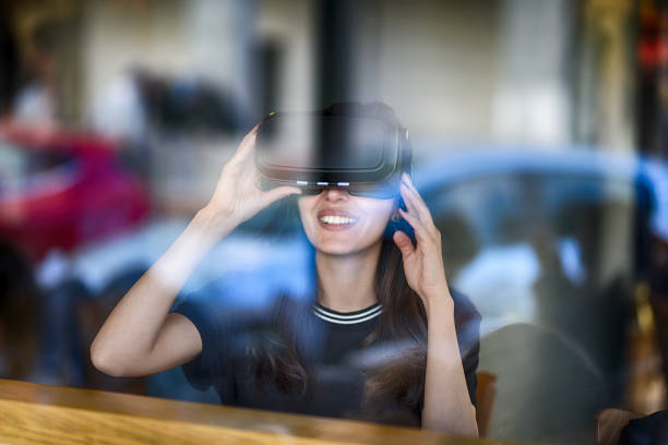 istock Young woman looking with VR behind the glass 944890506