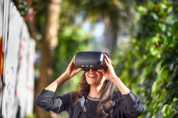istock Young woman wearing virtual reality glasses 944890930
