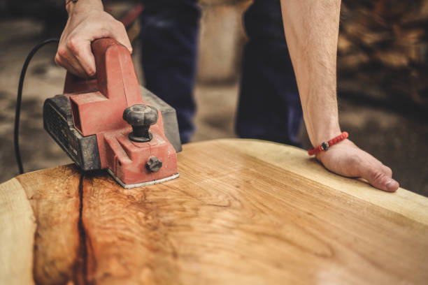 istock Focus carpenter sawing wood board 944893318