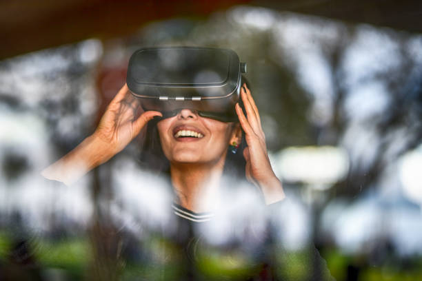 istock Young woman looking with VR behind the glass 944893988