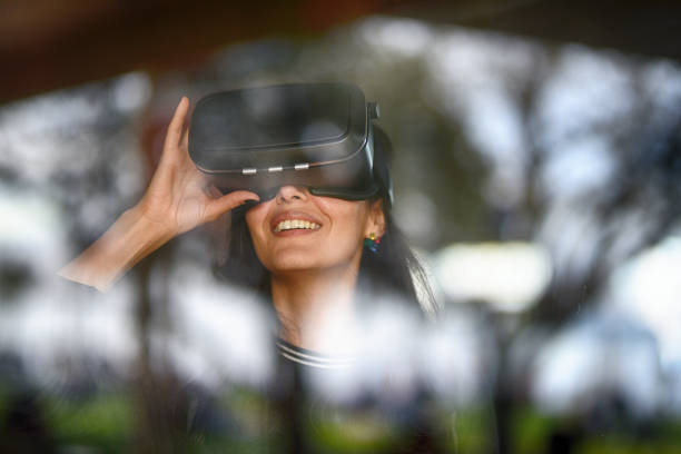 istock Young woman looking with VR behind the glass 944894122