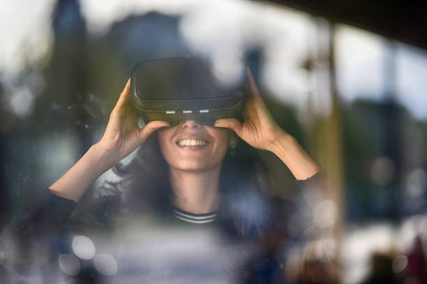 istock Young woman looking with VR behind the glass 944894558