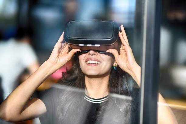 istock Young woman looking with VR behind the glass 944897084