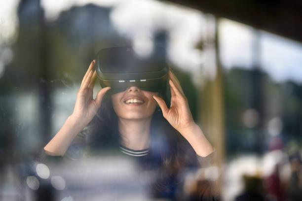 istock Young woman looking with VR behind the glass 944897116