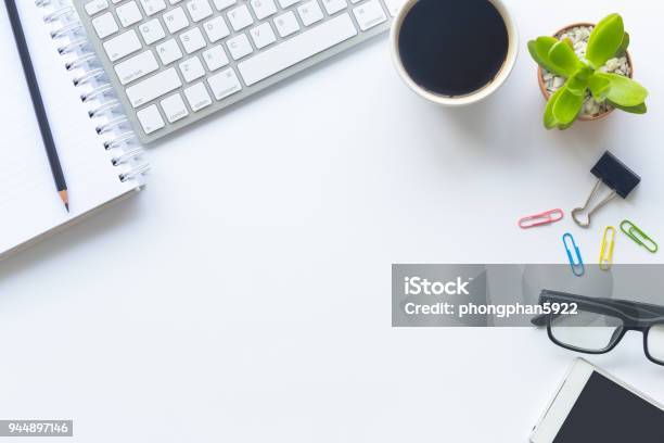 White Desk Office With Laptop Smartphone And Other Supplies With Cup Of Coffee Top View With Copy Space For Input The Text Designer Workspace On Desk Top View With Essential Elements On Flat Lay Stock Photo - Download Image Now