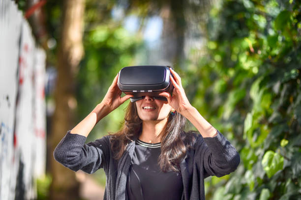 istock Young woman wearing virtual reality glasses 944897622