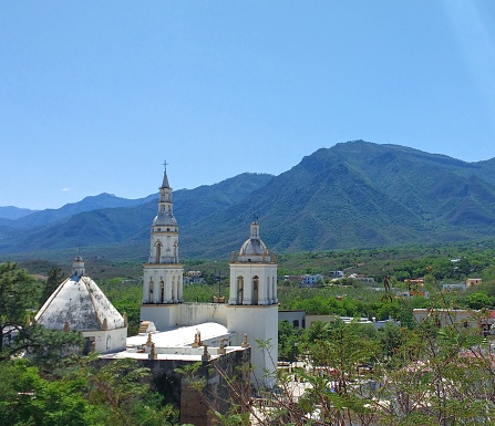 Parroquia Santiago Apostol Church in the Pueblo Magico of Santiago, Nuevo Leon Mexico with the Sierra Madre Oriental mountains in the background.