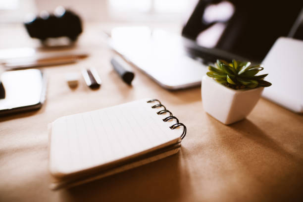 istock Close up focus view of notebook on the modern office desk set up. 944913934