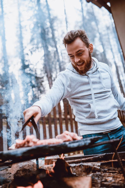 istock Handsome Male Preparing Barbecue on Family Picnic 944914478