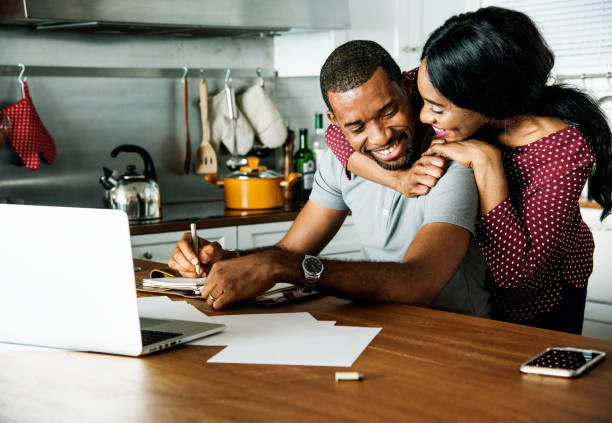 Black couple hugging together in a kitchen