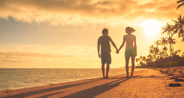 istock Couple walking on the beach 944914918
