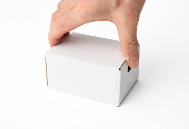 istock Isolated shot of holding a small blank cardboard box on white background 944919930
