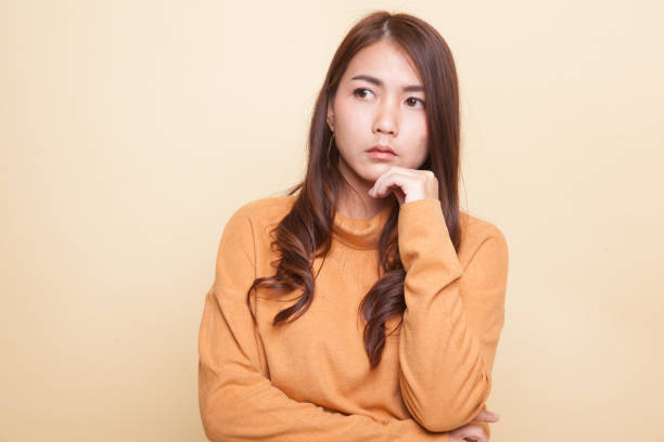istock Serious  young Asian woman  look away. 944936722