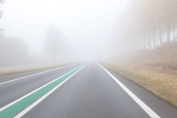 istock driving on a foggy road 944942356