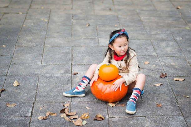 istock Little girl and Jack O'Lantern 944945610