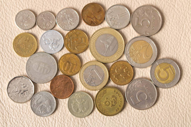 istock A lot of scattered coins on a leather background 944946120