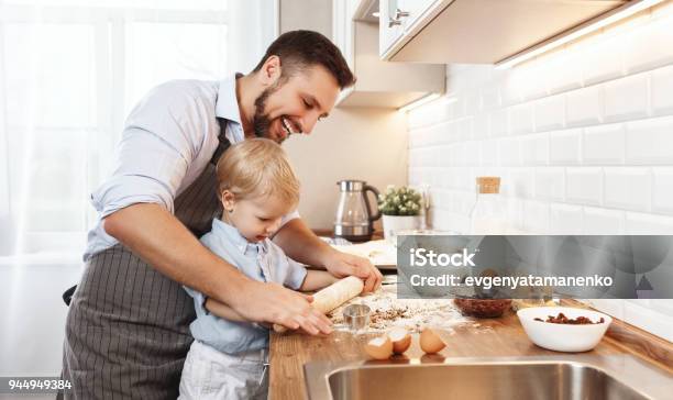 Happy Family In Kitchen Father And Child Baking Cookies Stock Photo - Download Image Now