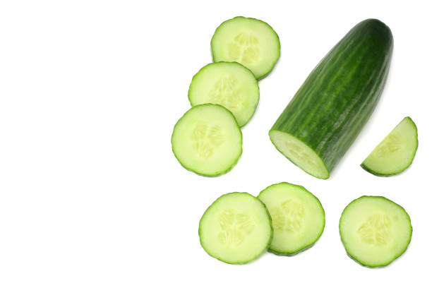 istock fresh cucumber slices isolated on white background. top view 944957318
