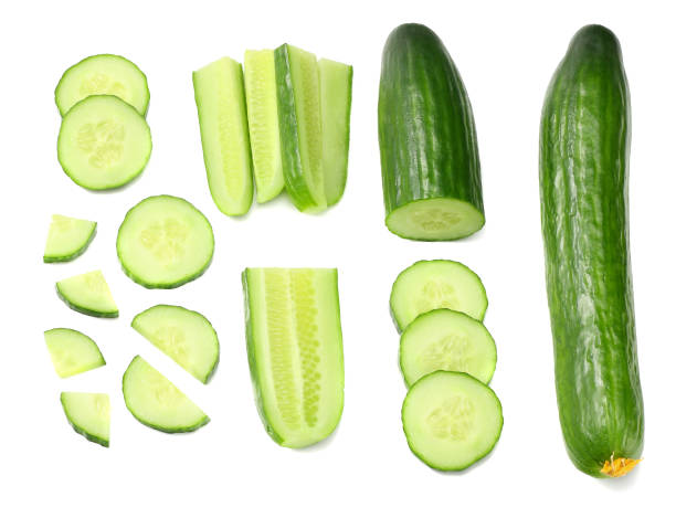 istock fresh cucumber slices isolated on white background. top view 944957362