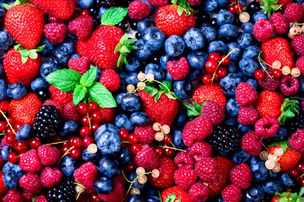 istock Macro colorful berries background. Top view. Summer food frame, border design. Assorted mix of strawberry, blueberry, raspberry, blackberry, currant, mint. Vitamin, vegan, vegetarian concept 944957878