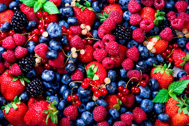 istock Macro colorful berries background. Top view. Summer food frame, border design. Assorted mix of strawberry, blueberry, raspberry, blackberry, currant, mint. Vitamin, vegan, vegetarian concept 944958472