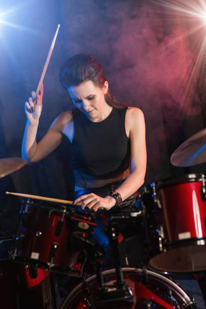 istock Young woman playing drums on stage 944965670