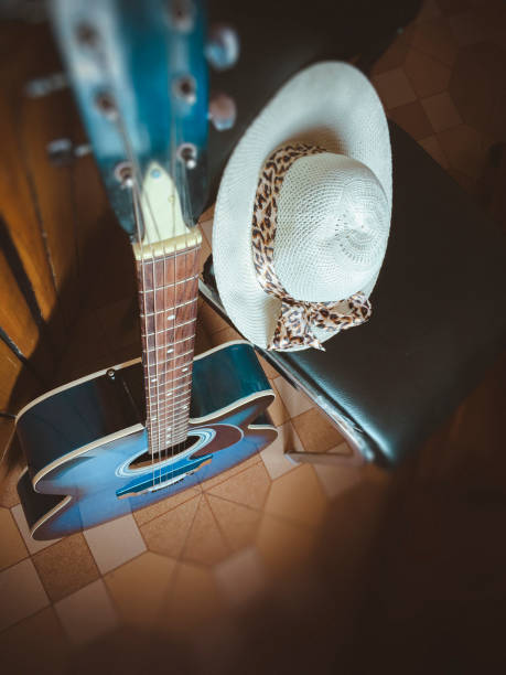 istock Acoustic guitar with lady's hat. 944965700