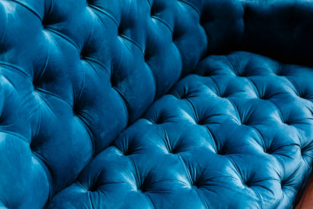 Velvet couch background texture with sunken buttons