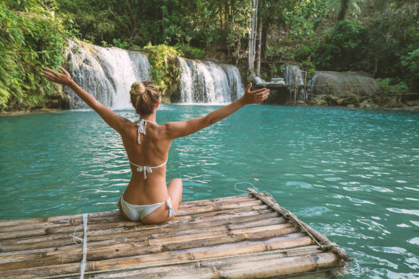 istock Girl embracing beautiful waterfall in the Philippines 944968466