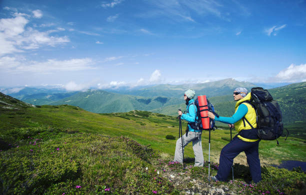 istock Summer hike in the mountains with a backpack and tent. 944969646