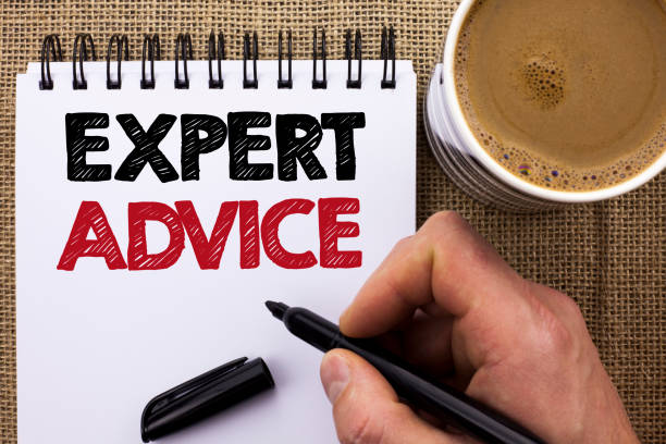 istock Text sign showing Expert Advice. Conceptual photo Professional Recommendation Suggestion Help Assistance written by Man Holding Marker on Notebook Book on the jute background Coffee Cup. 944969652