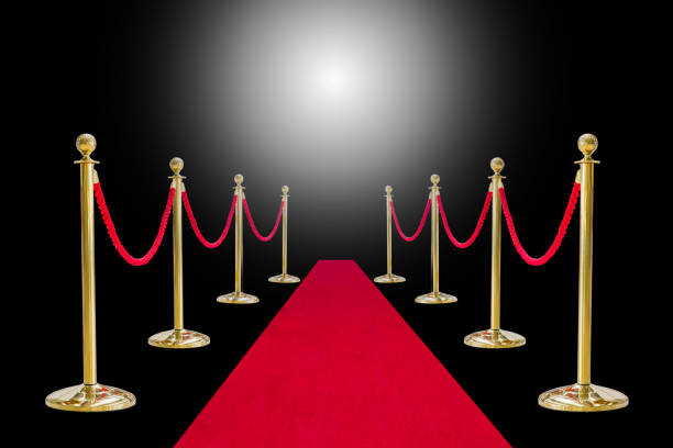 istock Golden pole barricade with red arpet isolated on white background 944969786
