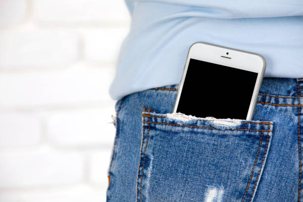 Close up of Smartphone with blank screen in jeans pocket. stock photo